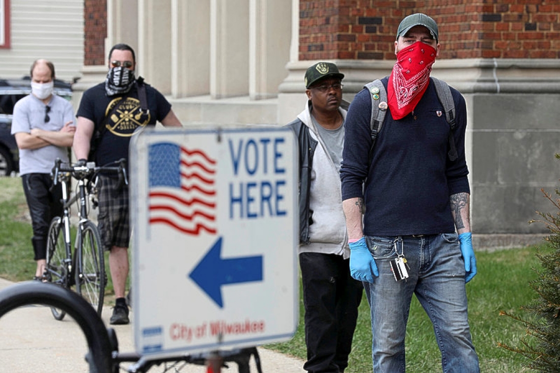 Long lines and frustration as Wisconsinites vote during coronavirus pandemic