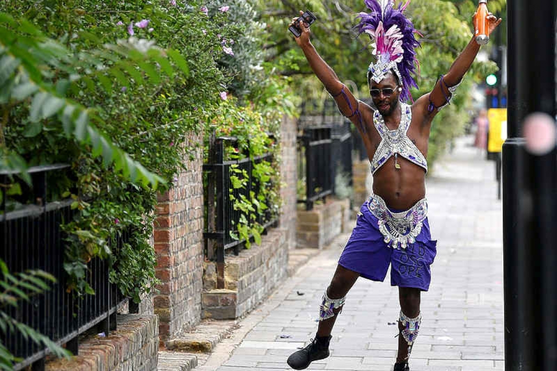 Revellers brighten Notting Hill's empty streets on carnival day