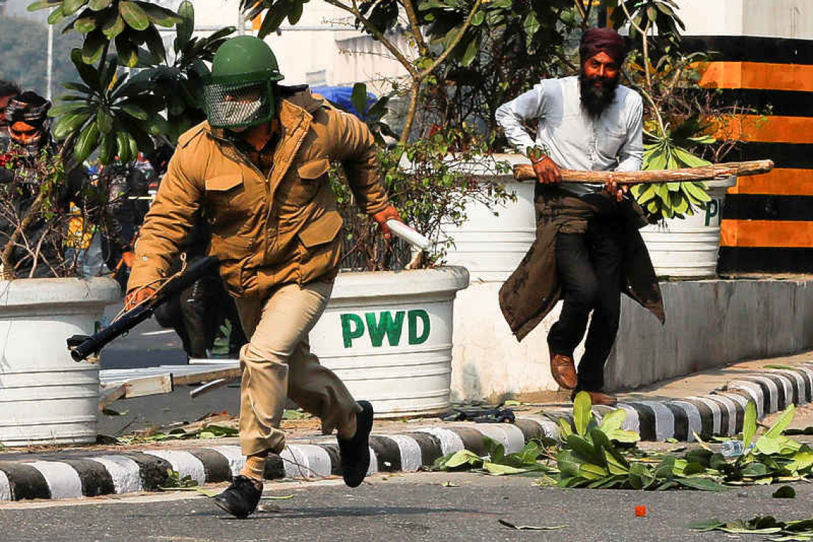 Indian farm protesters battle police to plant flags at historic Red Fort