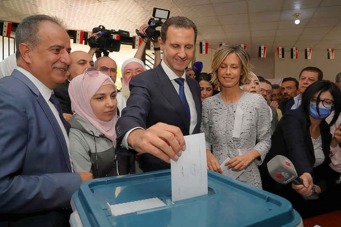 Assad votes in former rebel town, site of chemical attack