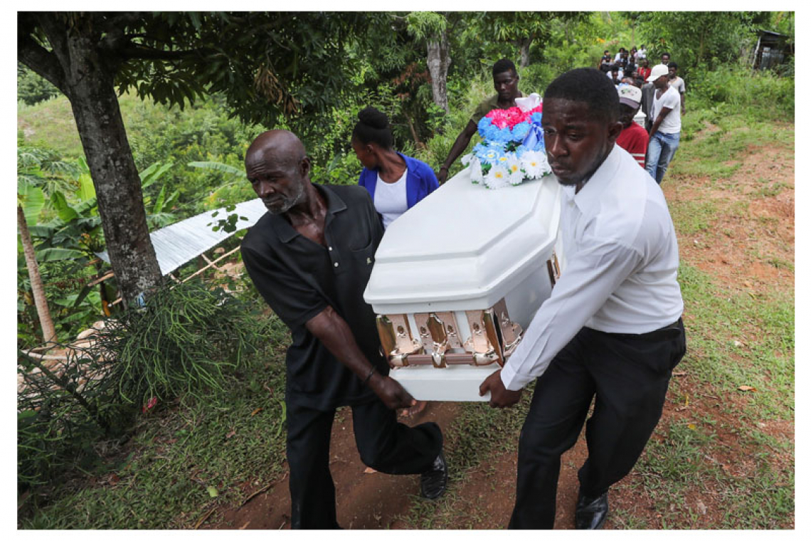 ‘Everyone was crying’: grieving Haitians  bury their dead in week following quake