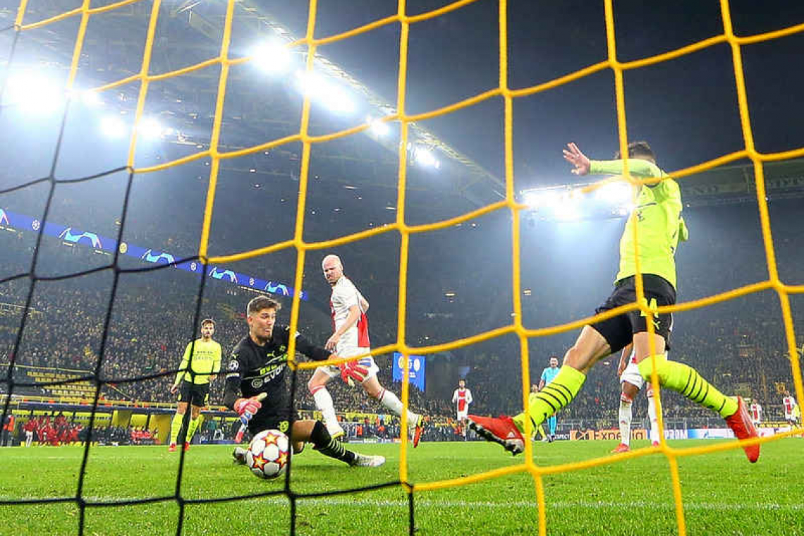    Ajax win at Dortmund to qualify for last 16