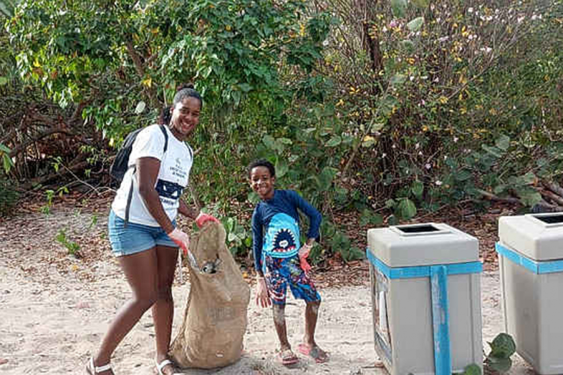 100 people collect trash  from Mullet Bay Beach