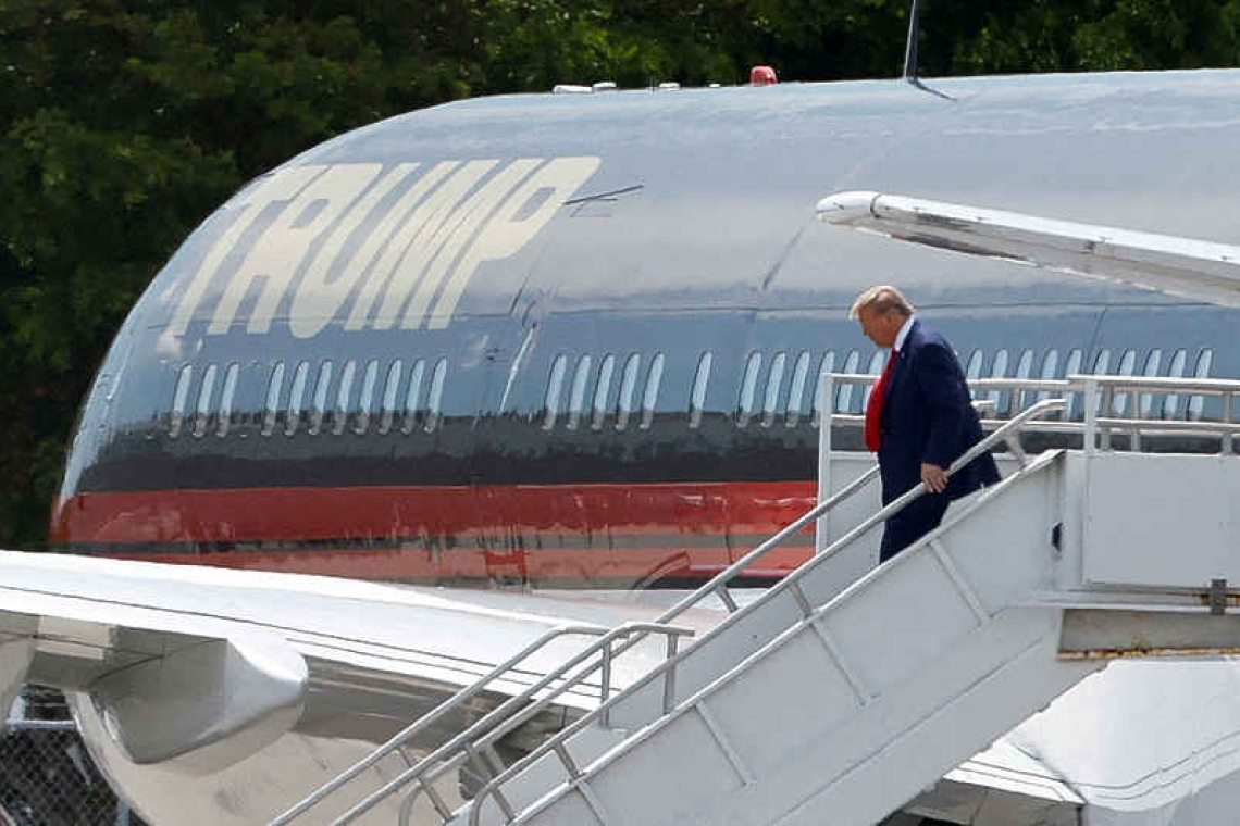 Trump arrives in Florida to face charges, maintains lead in poll 