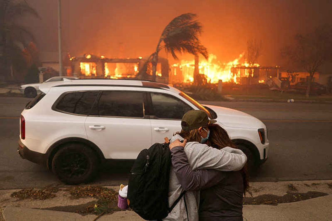 Los Angeles surrounded by out-of-control wildfires; at least 5 dead