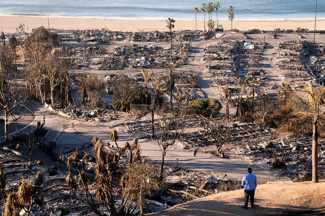 LA races to contain wildfires  before severe weather returns