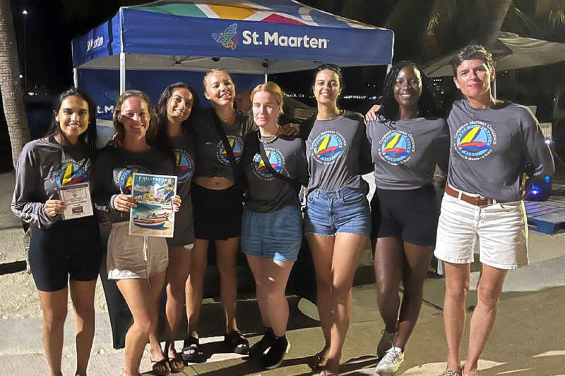 Eight members of the Island Water World sailing team receiving sports performance awards on the boardwalk. Photo Laurens Morel.